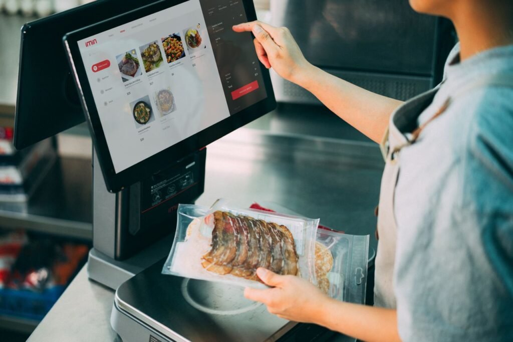The Art of Drawing Readers In: Your attractive post title goes here Person using digital POS system in a restaurant for cashless food payment.